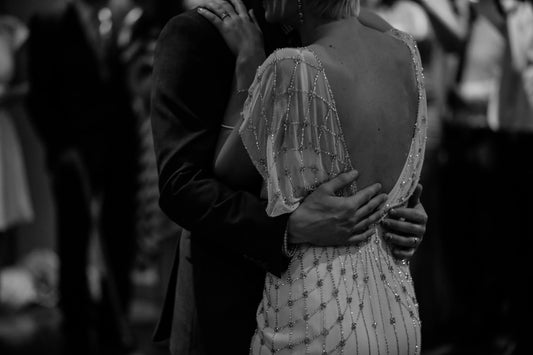 a bride and groom dancing black and white photo