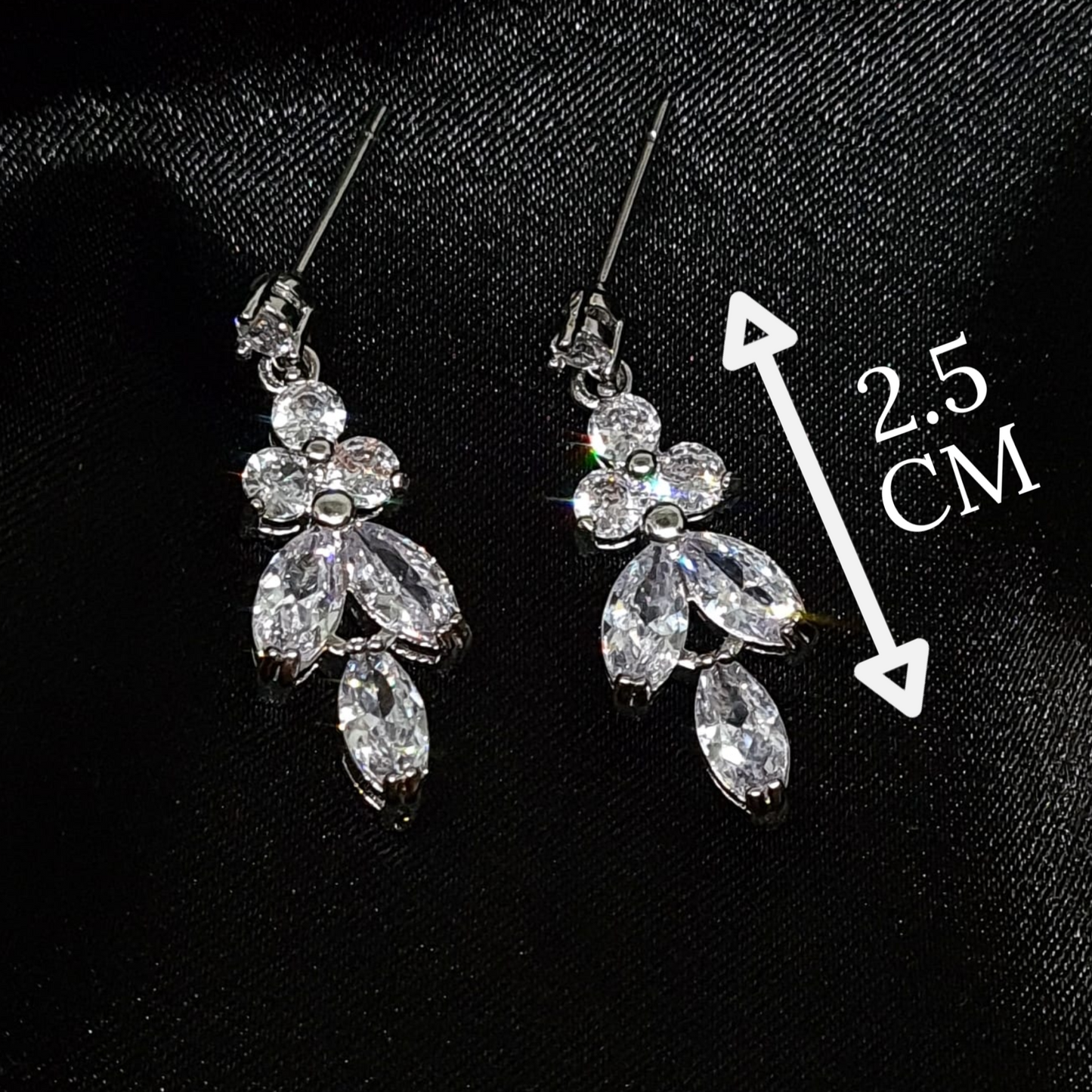 Cubic zirconia earrings elegantly showcased inside a black fabric..