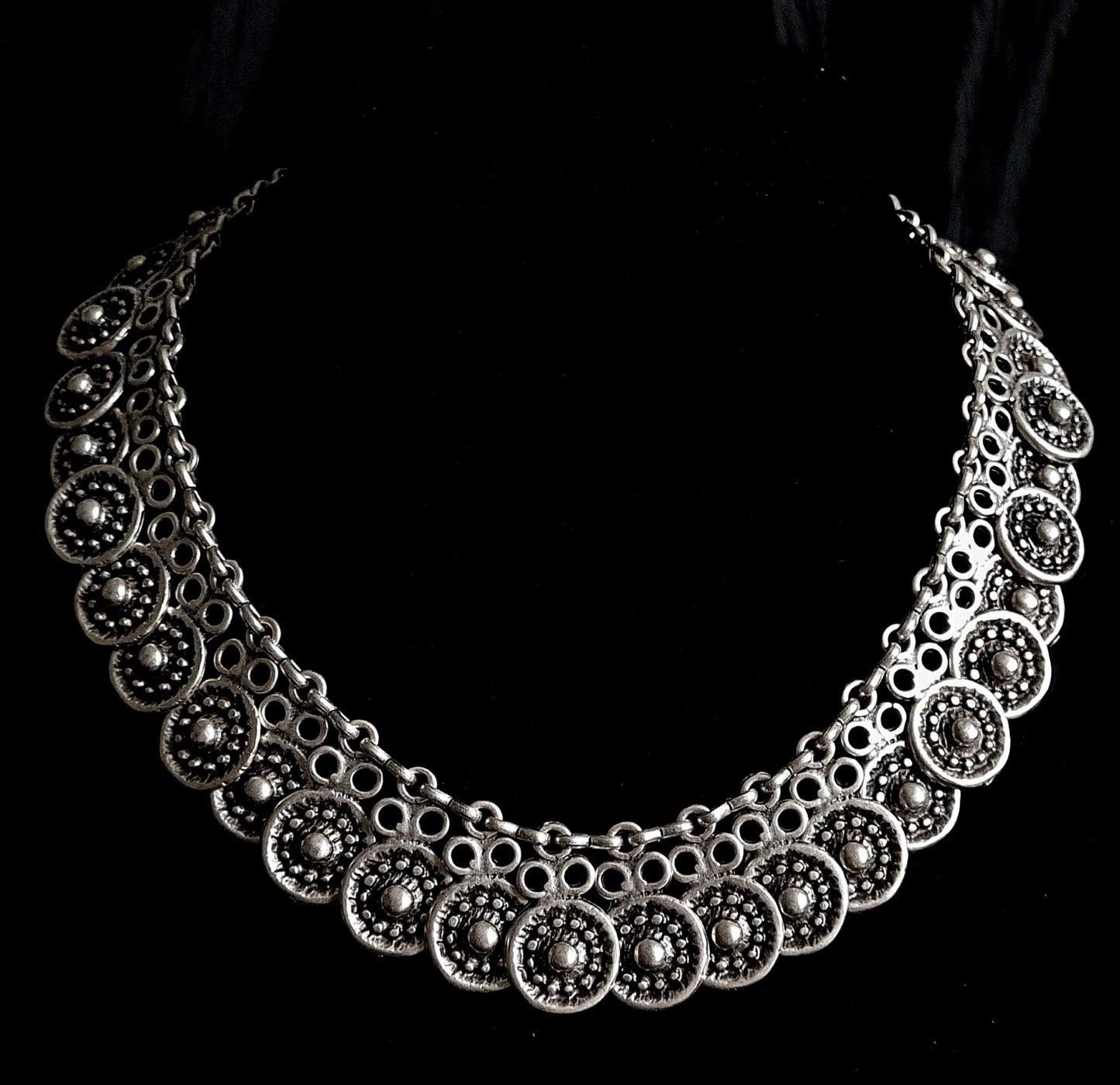 Enya Necklace showcasing its intricate filigree design and sparkling accents.