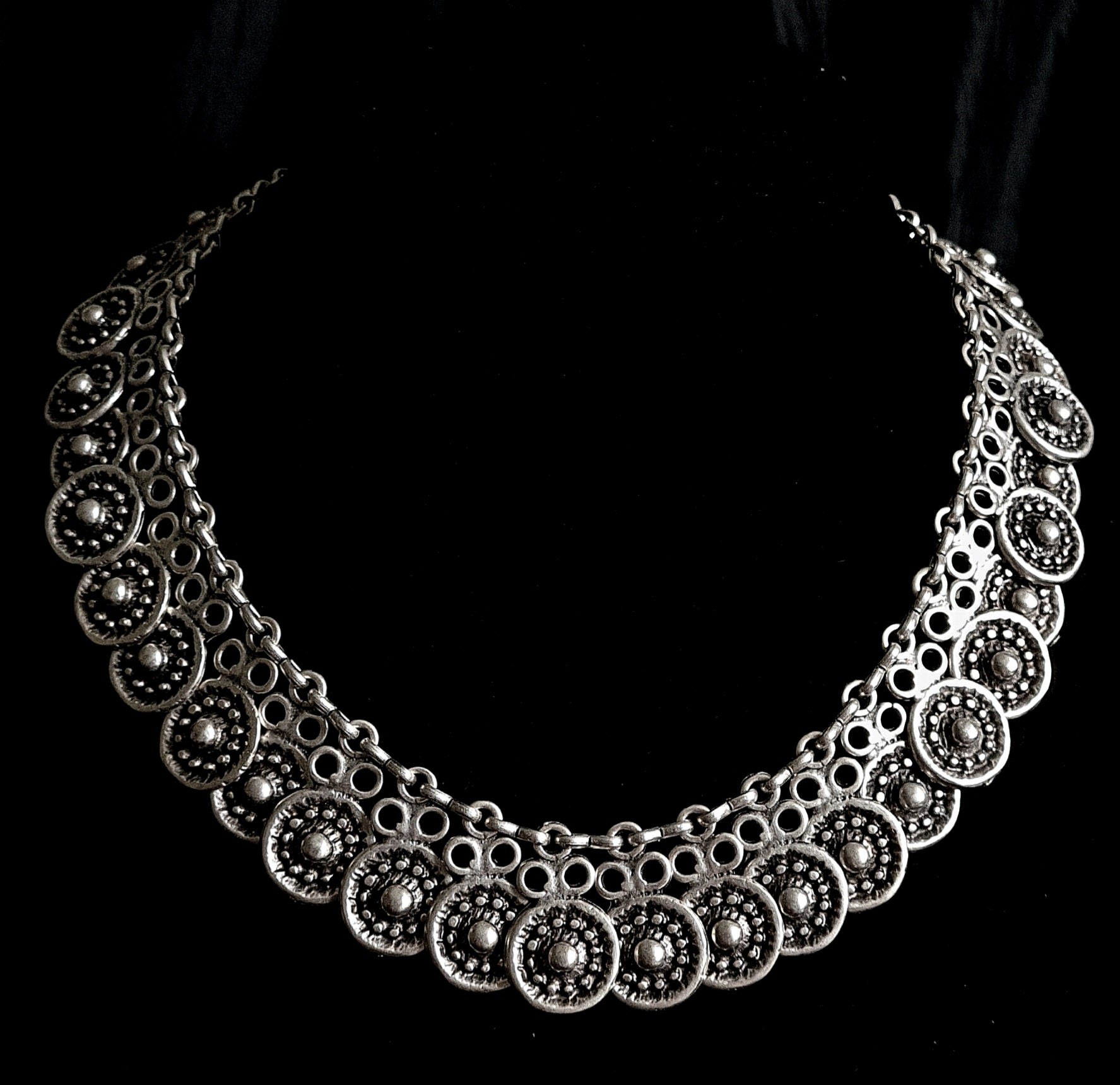 Enya Necklace showcasing its intricate filigree design and sparkling accents.