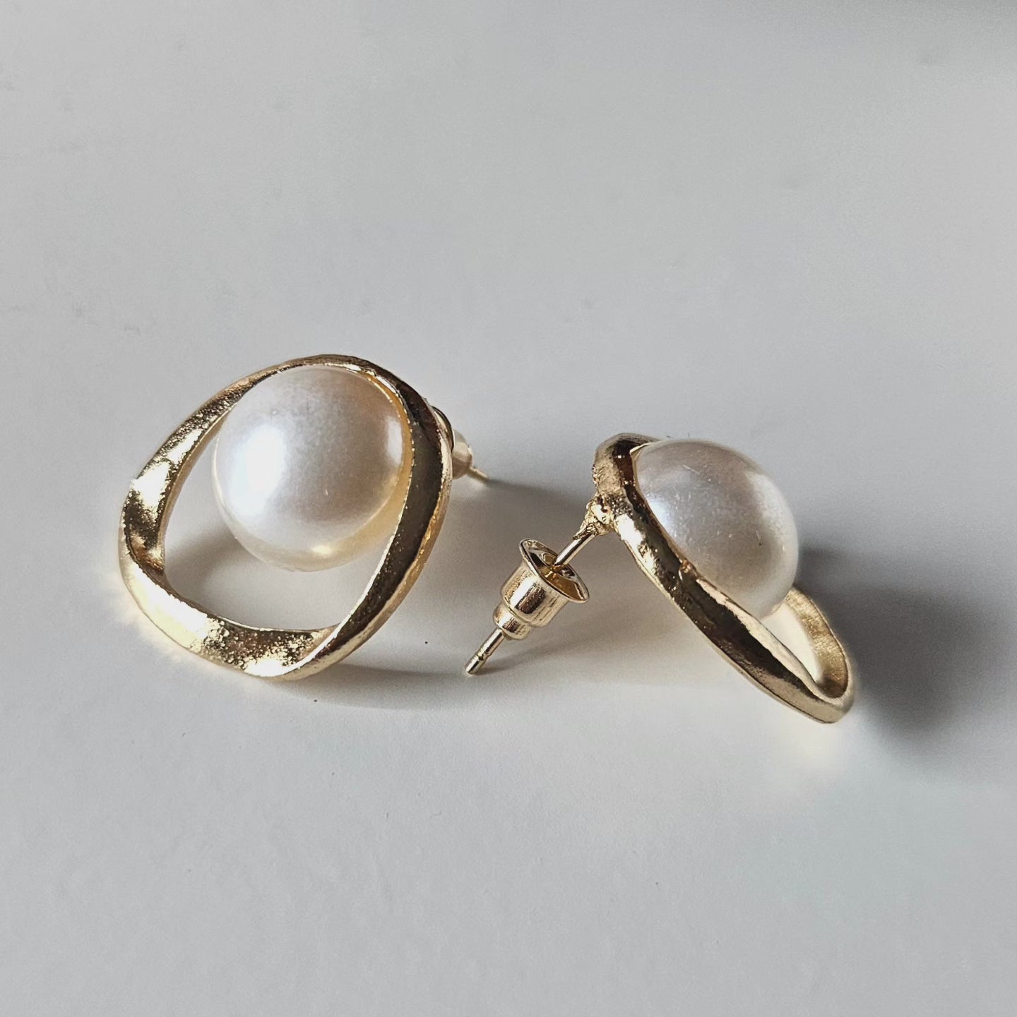 Marigold Pearl Stud Earrings with a gold-plated setting.