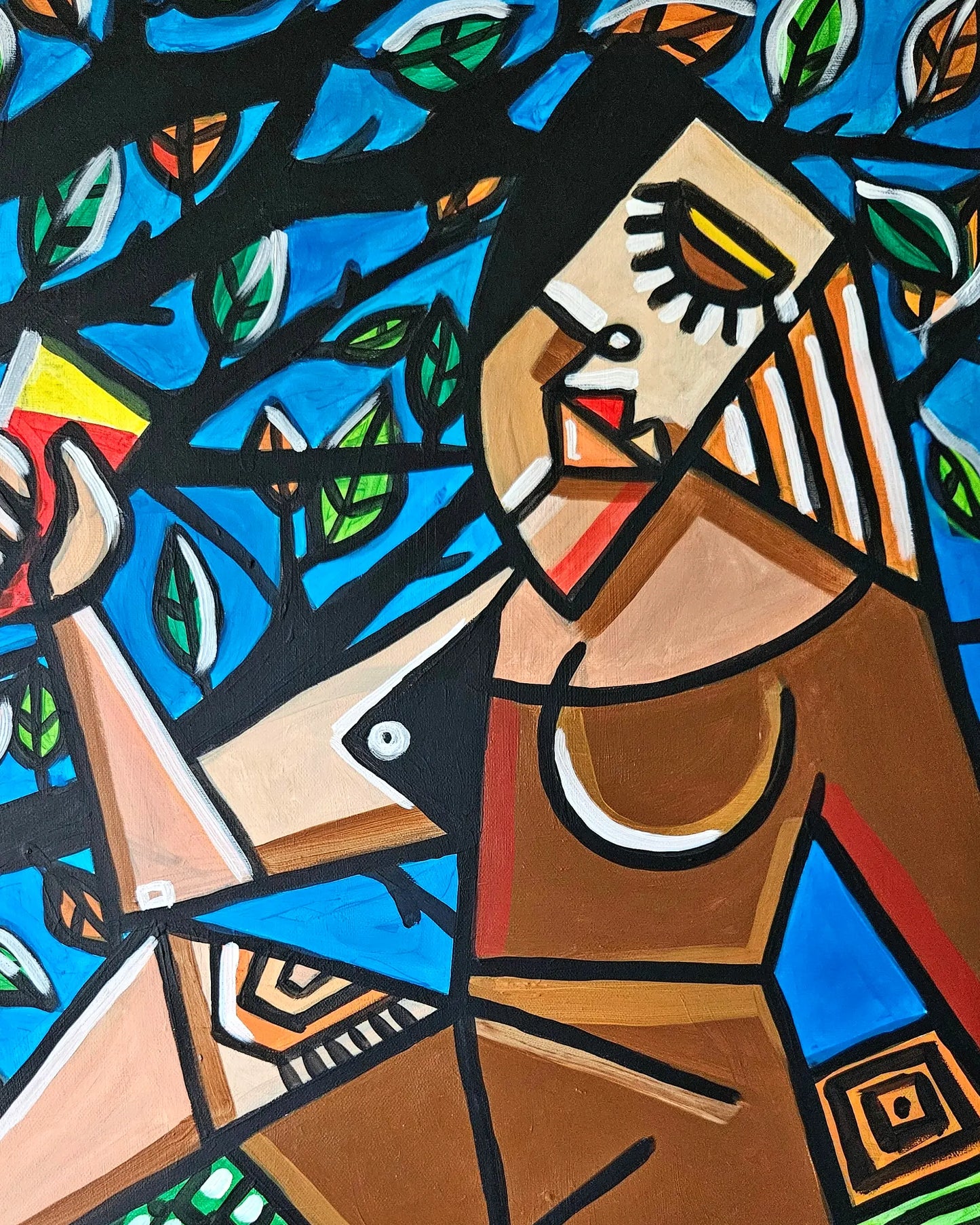 A woman with bold features sits under a leafy tree, holding a drink and exuding a sense of tranquility.