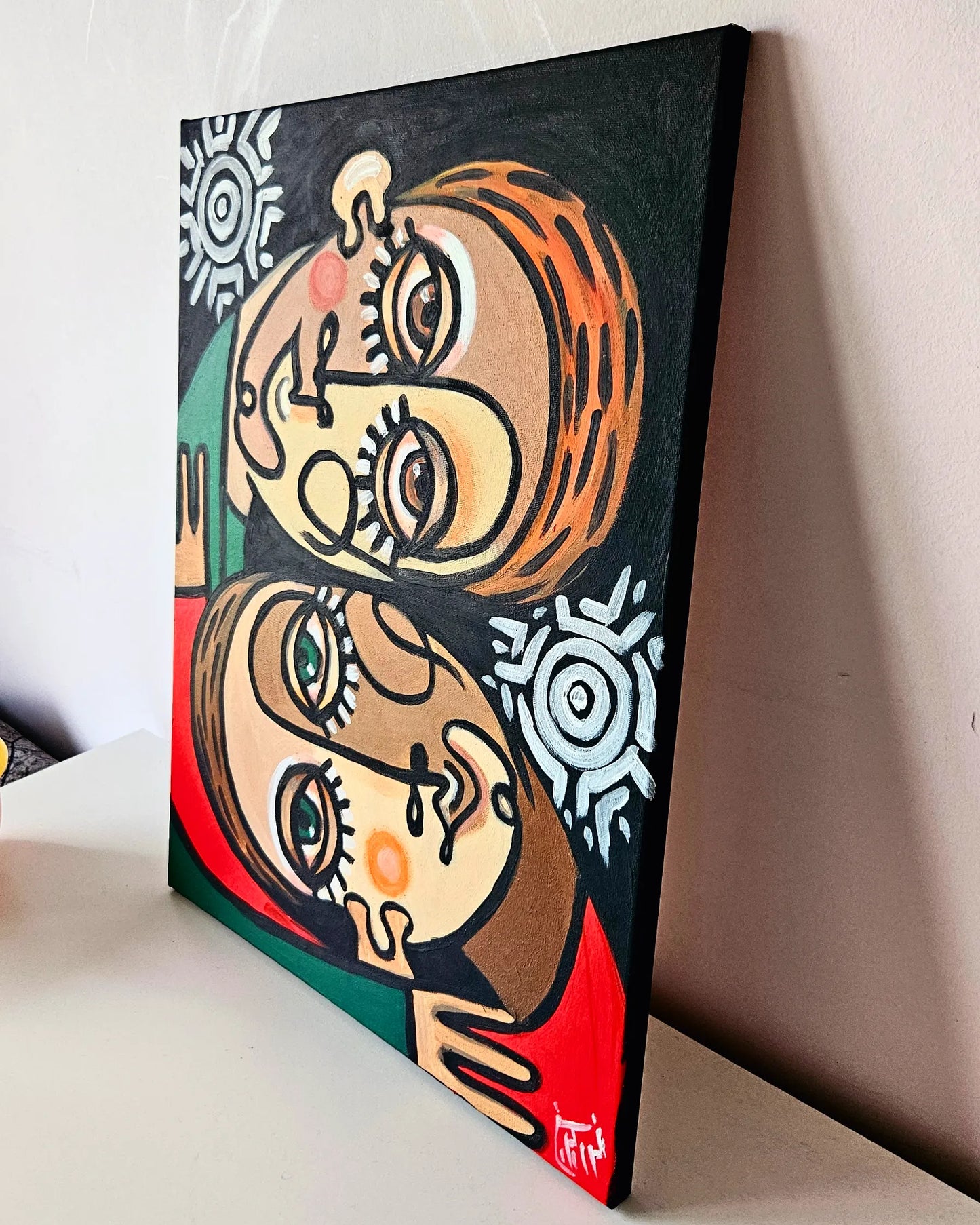 A vibrant abstract painting of two people embracing, with bold colors and expressive features.