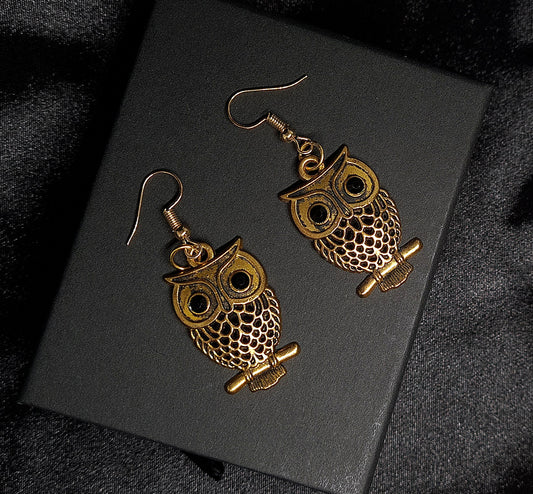 Astrid Earrings sparkling golden metal and adorable owl charm with exquisite details.