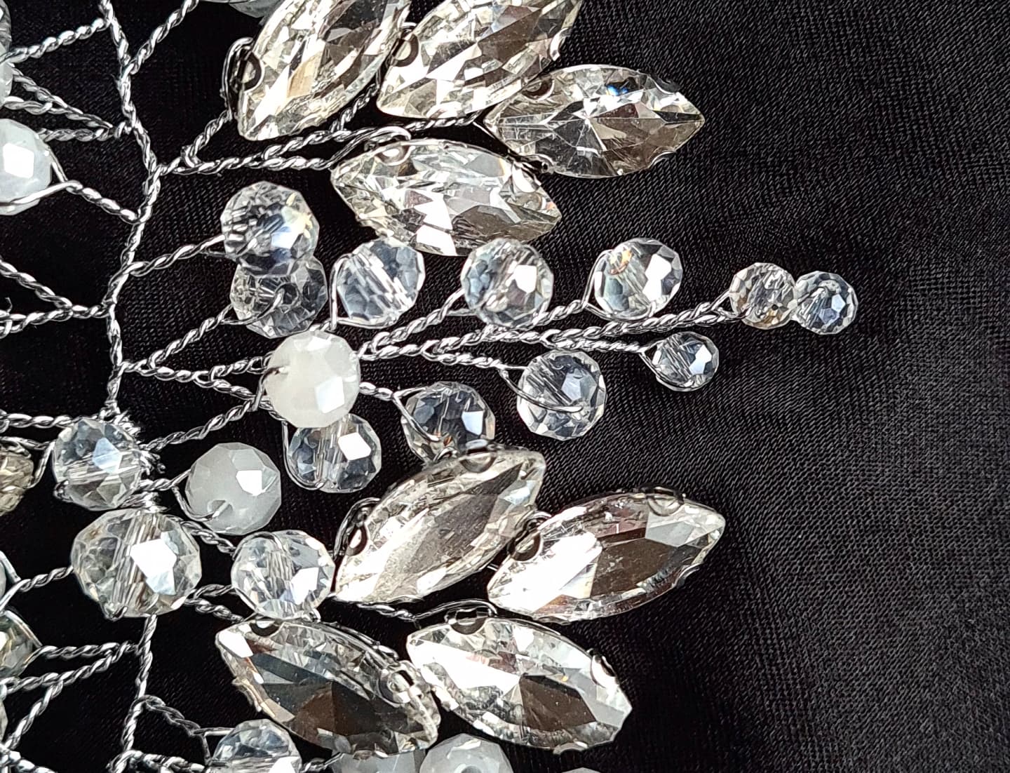 Intricate silver bridal headpiece, "Angela Headpiece" features sparkling stones, perfect for any hair style