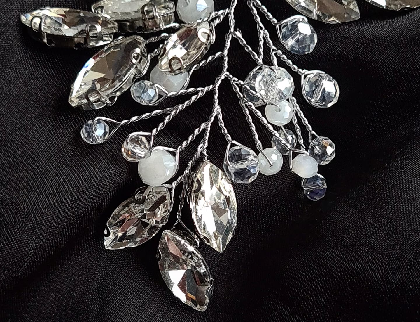 Intricate silver bridal headpiece, "Angela Headpiece" features sparkling stones, perfect for any hair style