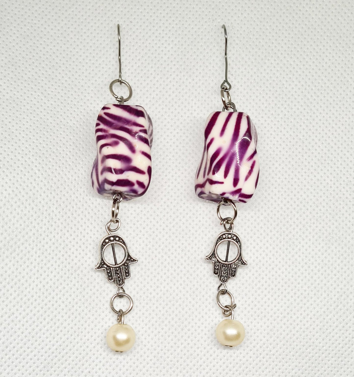 Bella Earrings a delicate dangle drop design with a captivating Hamsa charm.