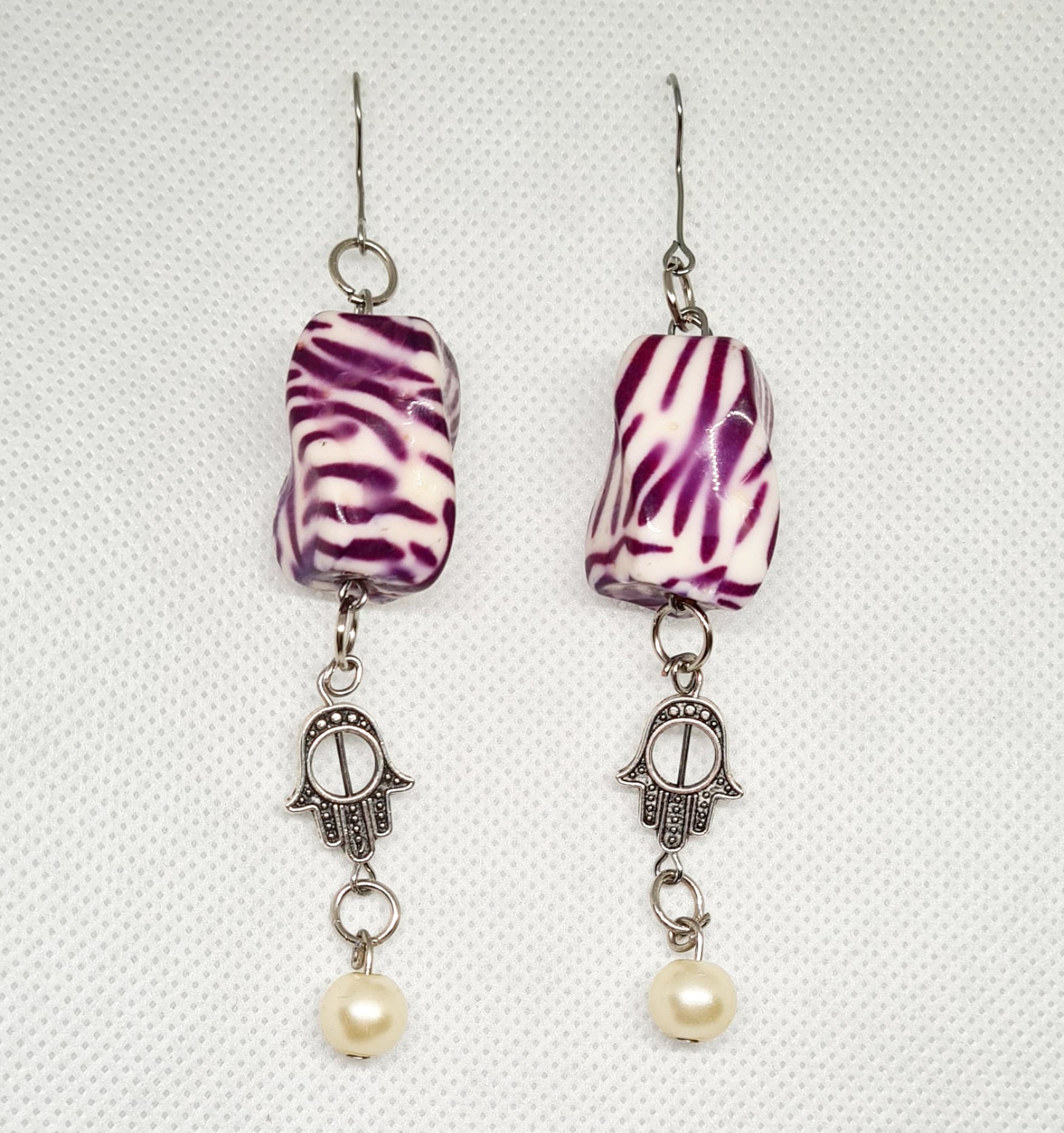 Bella Earrings a delicate dangle drop design with a captivating Hamsa charm.