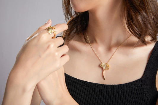 woman in black tube top wearing gold necklace and ring