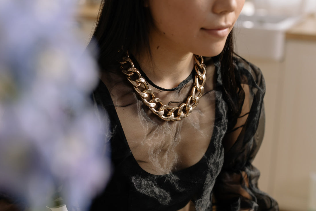 /woman-in-black-top-wearing-a-chain-necklace