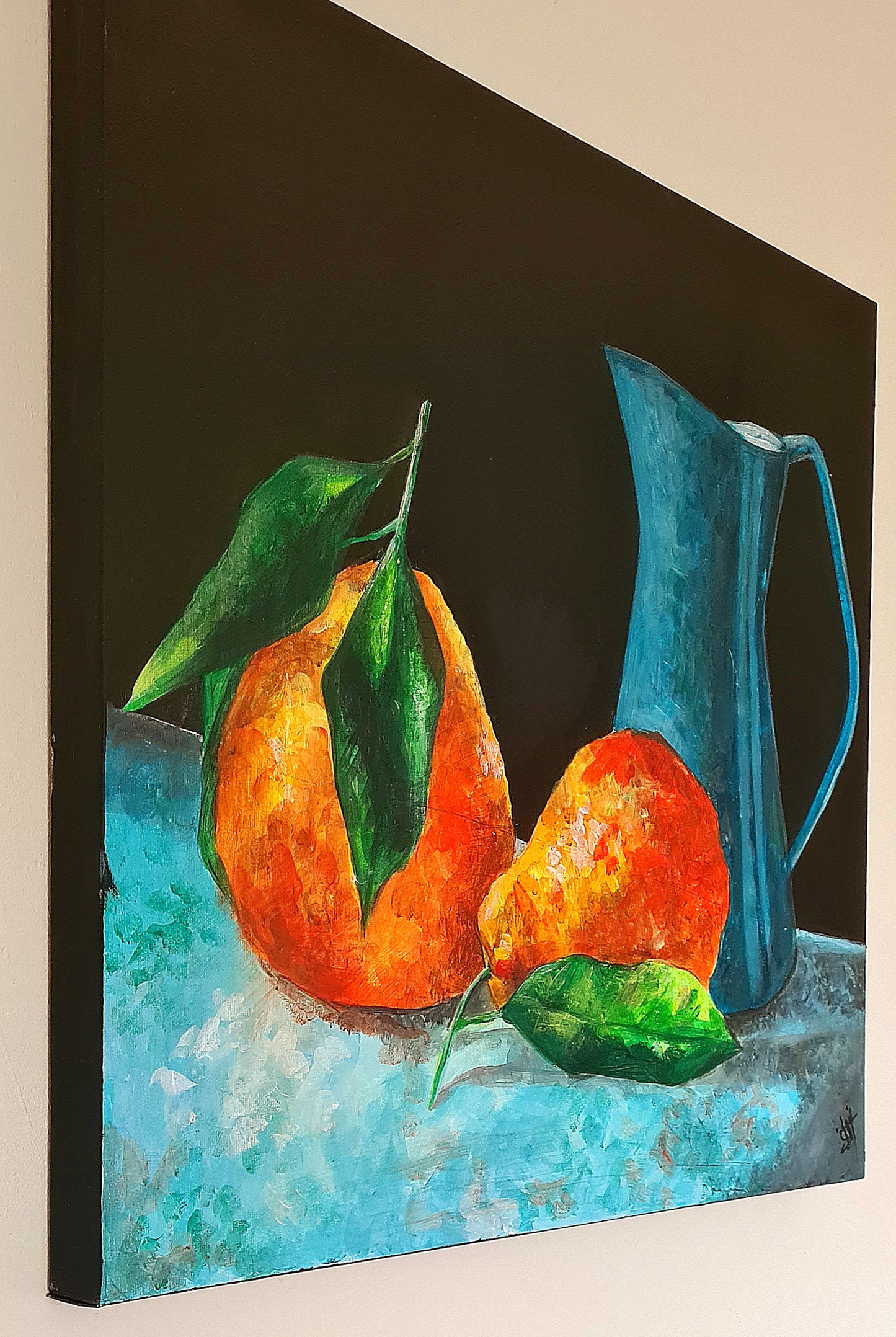 A painting of two orange pears and a blue pitcher on a table. The pears are ripe and full, with their smooth skin a deep orange color. The pitcher is a deep blue color, with a simple design. The background of the painting is a neutral gray color.