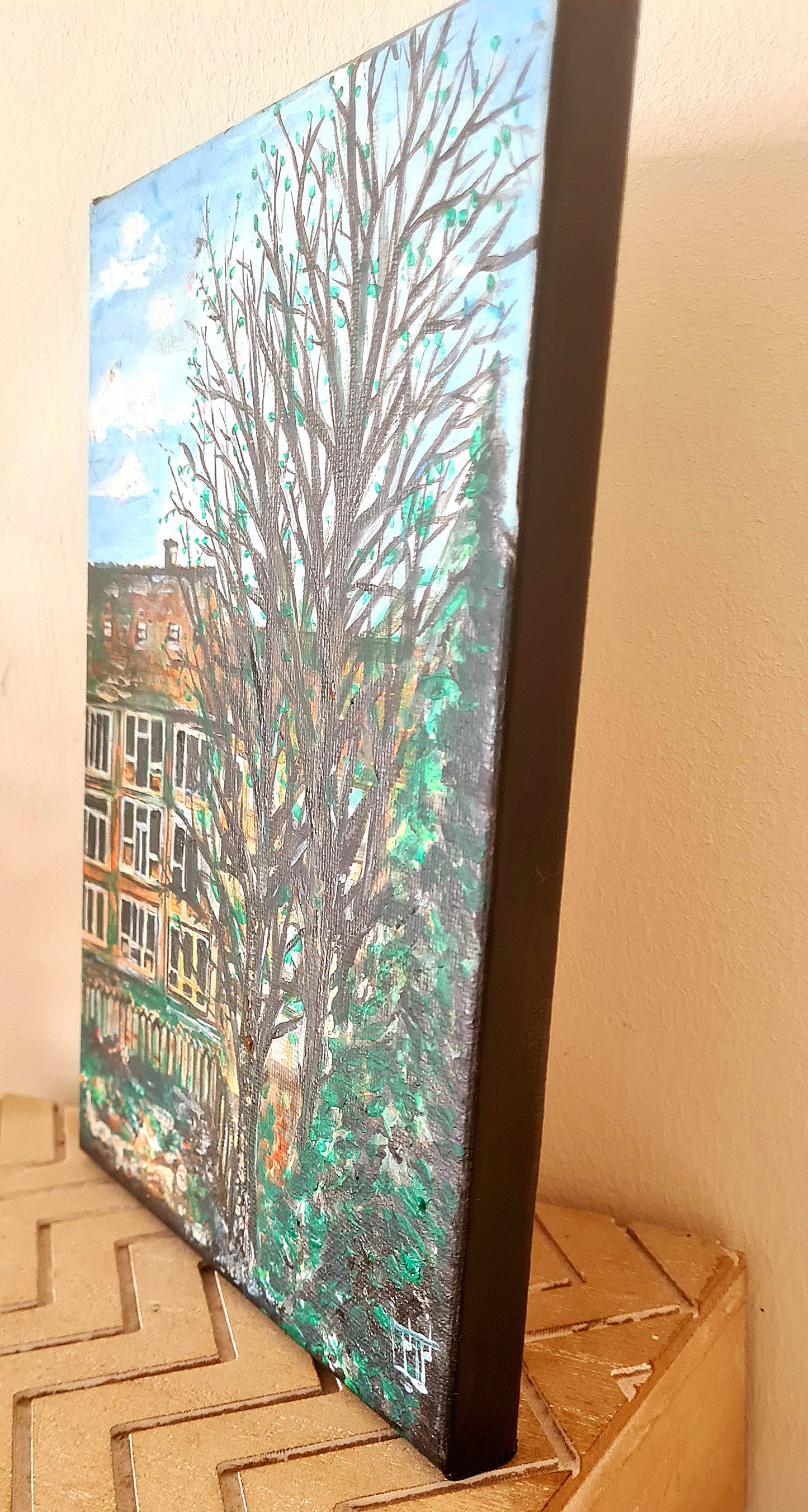 Acrylic painting of Amsterdam with tall tree, red brick building, muted colors, and dreamy background.