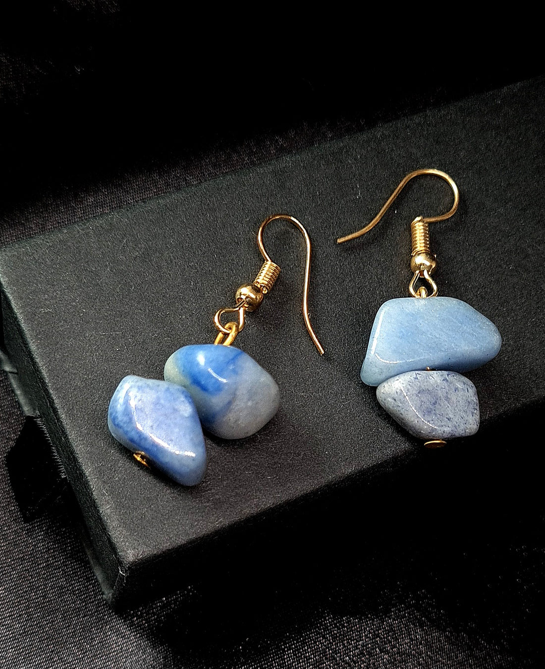 handmade blue earrings showcased on black jewelry box
