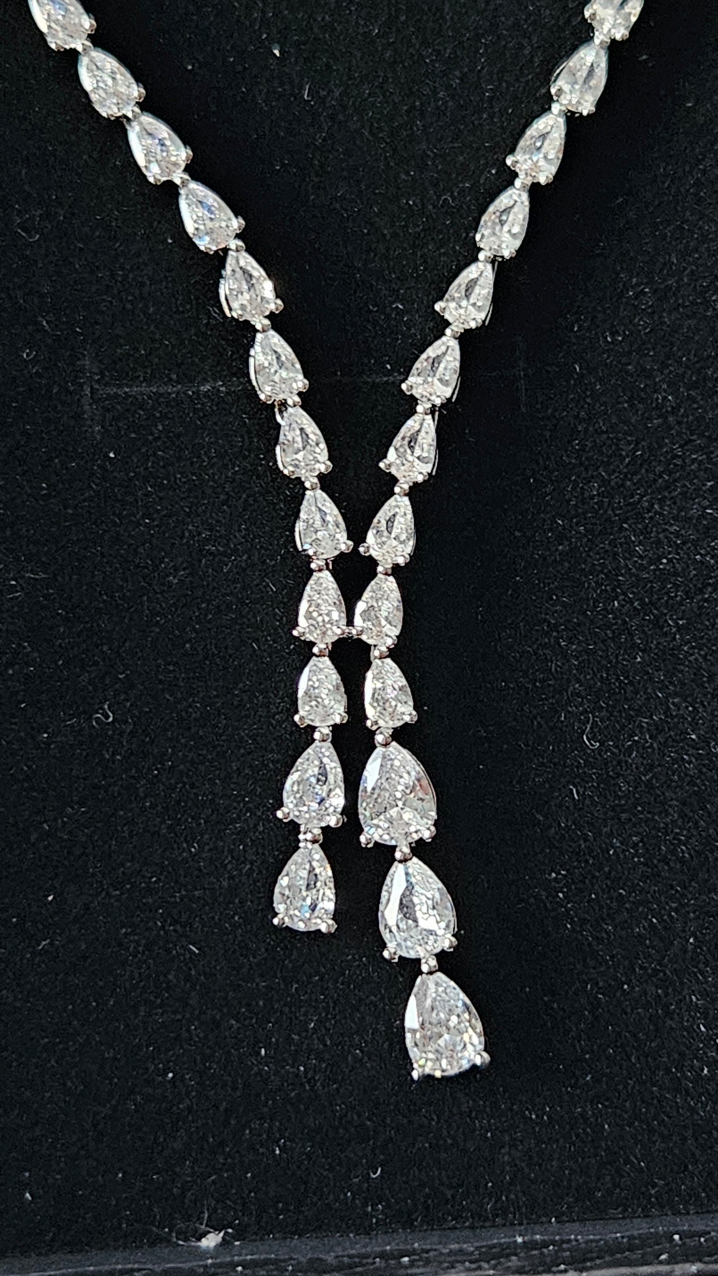 A high-resolution macro shot of the La Pasión Dilara silver necklace pendant. The focal point is a 3.81 cm (1.5 inch) pear-cut teardrop stone suspended from a delicate botanical vine of marquise-cut silver settings, radiating high-end luxury and precision craftsmanship.