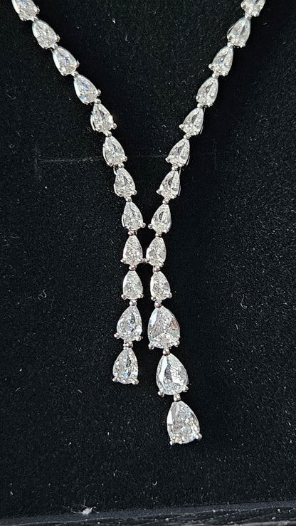 A high-resolution macro shot of the La Pasión Dilara silver necklace pendant. The focal point is a 3.81 cm (1.5 inch) pear-cut teardrop stone suspended from a delicate botanical vine of marquise-cut silver settings, radiating high-end luxury and precision craftsmanship.