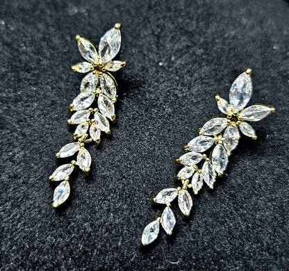Macro photography of the La Pasión Regal Gold Earrings. The marquise stones are arranged in a botanical spray, reflecting light with exceptional clarity. Perfect for high-end social media marketing and web catalogs.