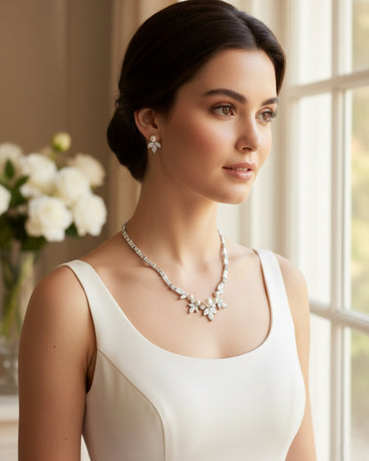 Side profile of a professional model showcasing an elegant bridal jewelry set against a soft, sunlit interior backdrop.