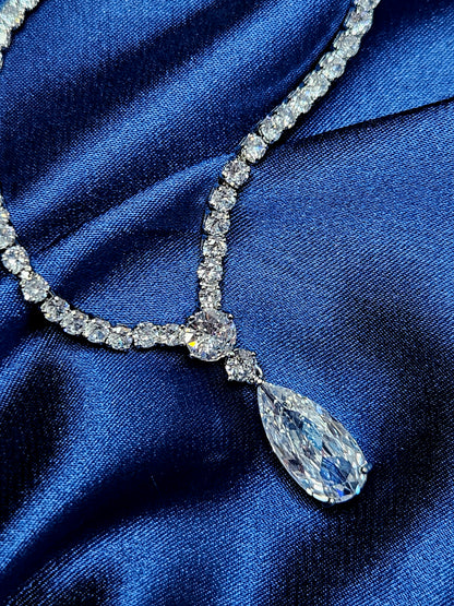 Macro editorial shot of the Tear Necklace pendant, showcasing the intricate pavé setting and the diamond-like brilliance of the central cubic zirconia stone. Professional luxury jewelry detail highlighting high-quality craftsmanship and light-reflecting clarity