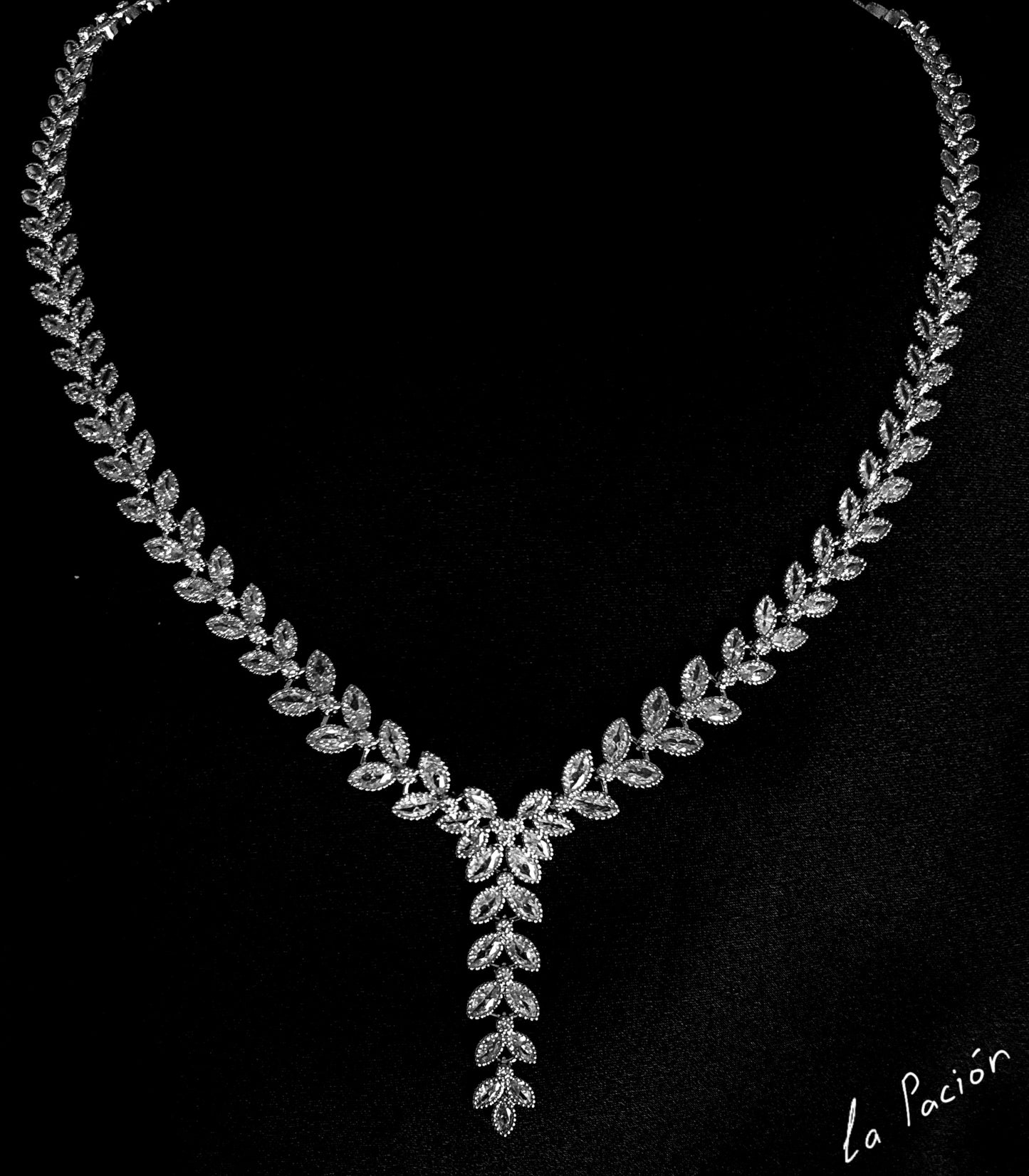  silver necklace sparkling with zirconia Diamonds displayed on a black background.