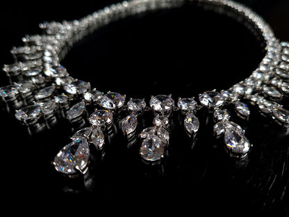  Close-up view of a diamond necklace sparkling with zirconia Diamonds displayed on a black table. 
