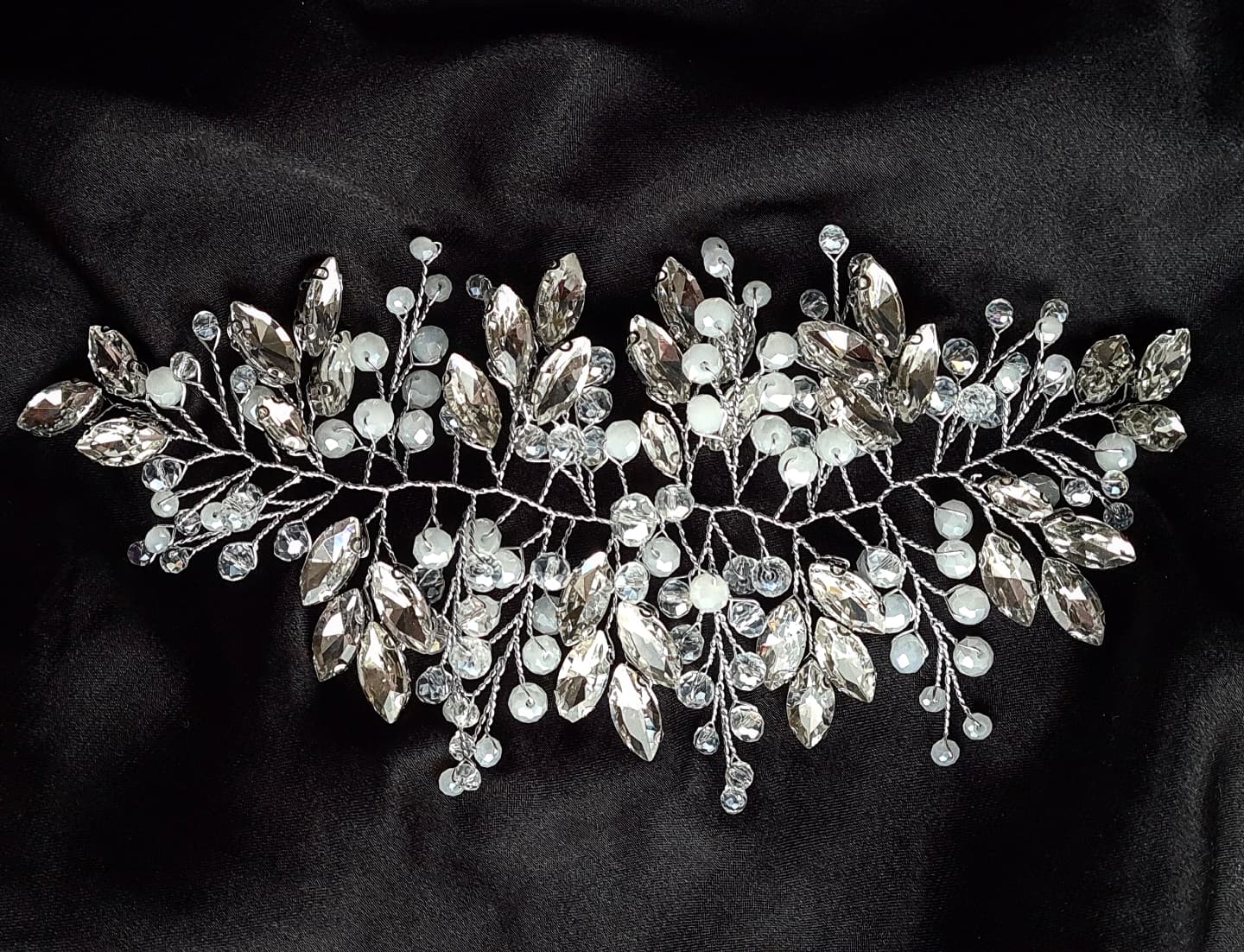 Intricate silver bridal headpiece, "Angela Headpiece" features sparkling stones, perfect for any hair style