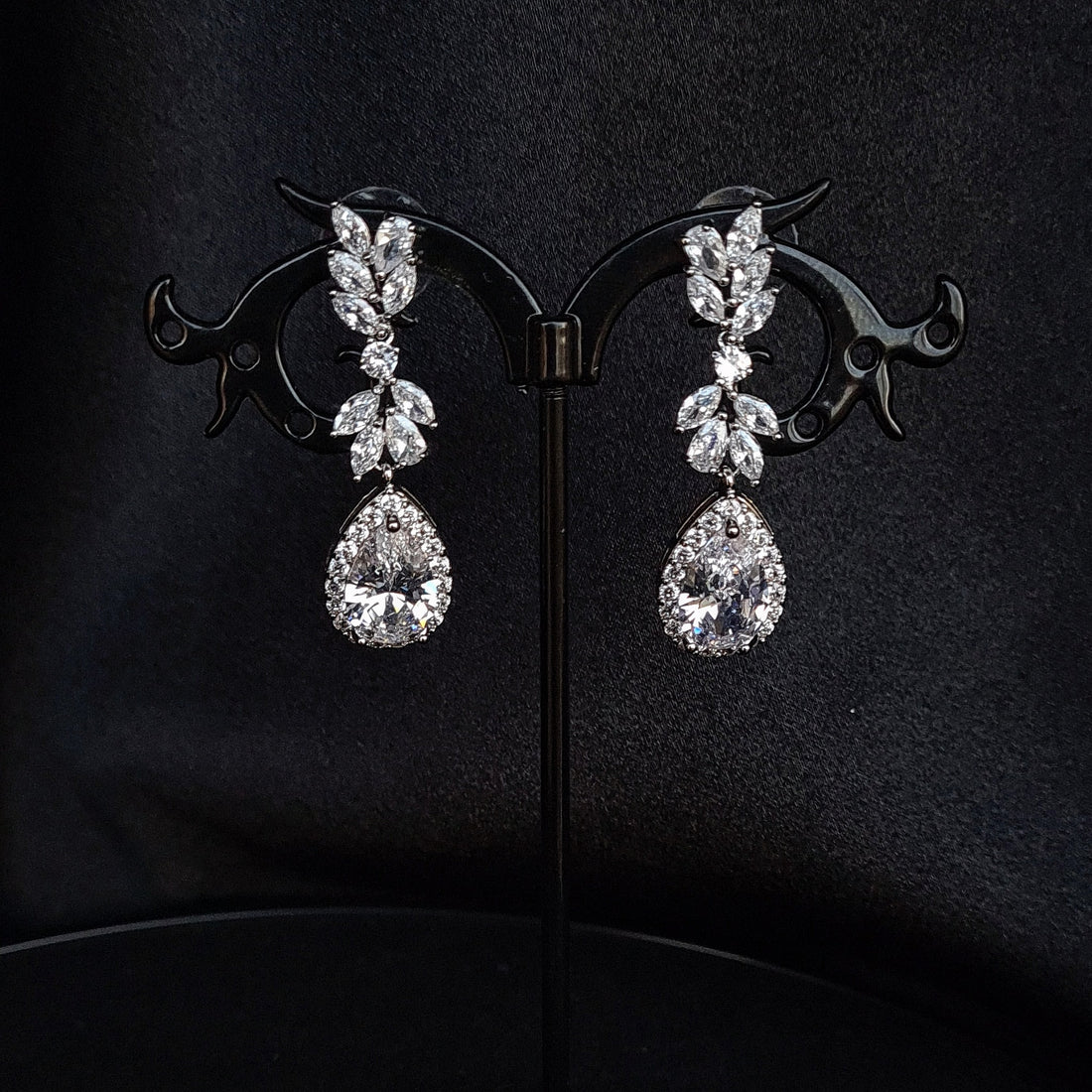 cubic zirconia earrings on a black jewelry stand